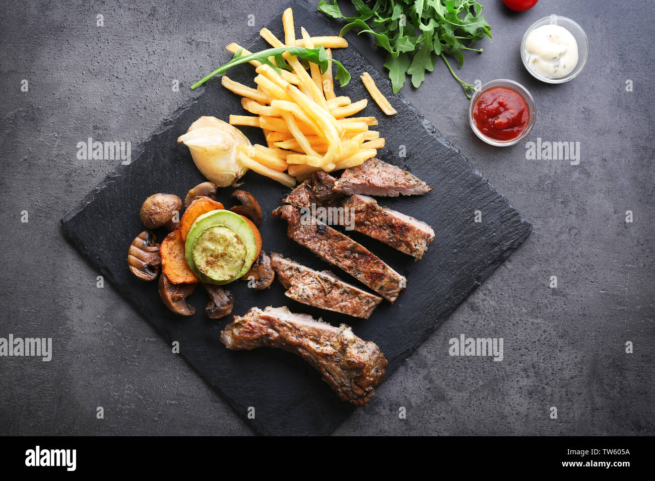 Delicious grilled steak frites on slate plate Stock Photo Alamy
