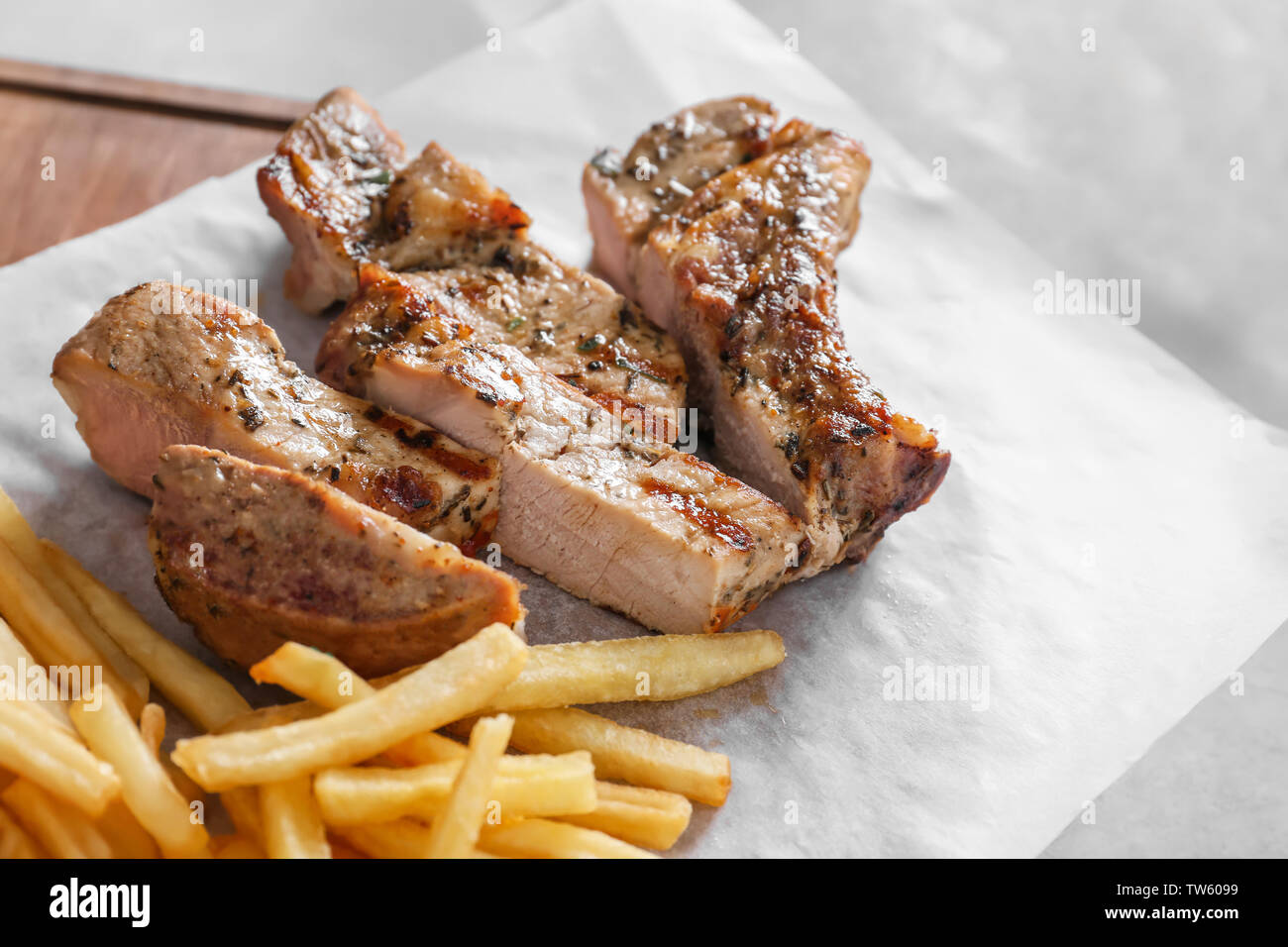 Delicious grilled steak frites on waxed paper Stock Photo Alamy