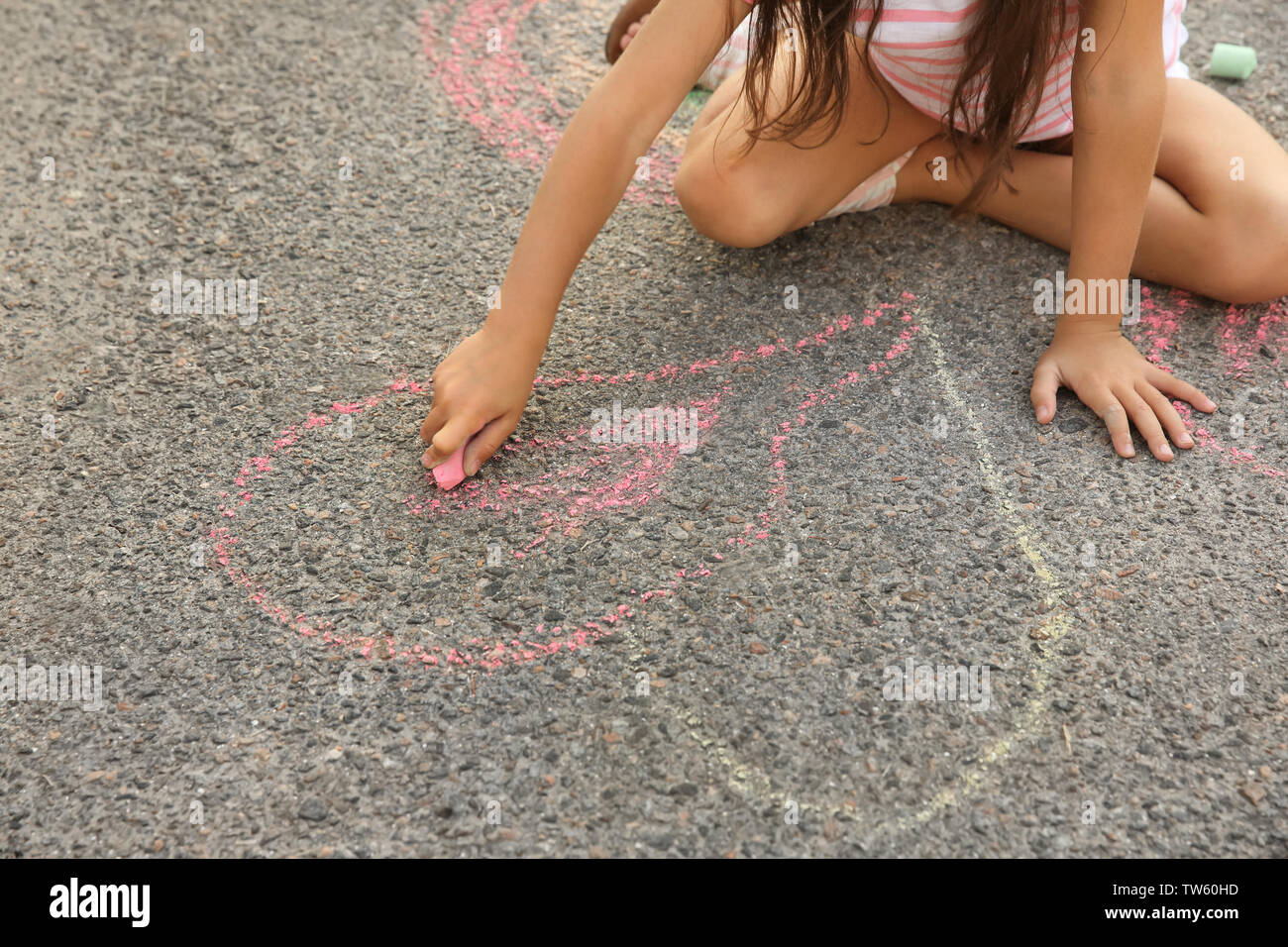 Little girl drawing with chalk on asphalt, outdoors Stock Photo - Alamy