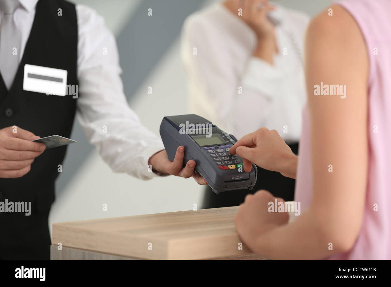 Woman paying for hotel room at reception Stock Photo Alamy