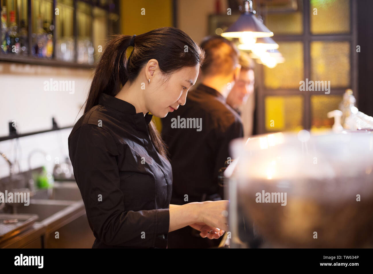 waitress serving in modern cafe Stock Photo