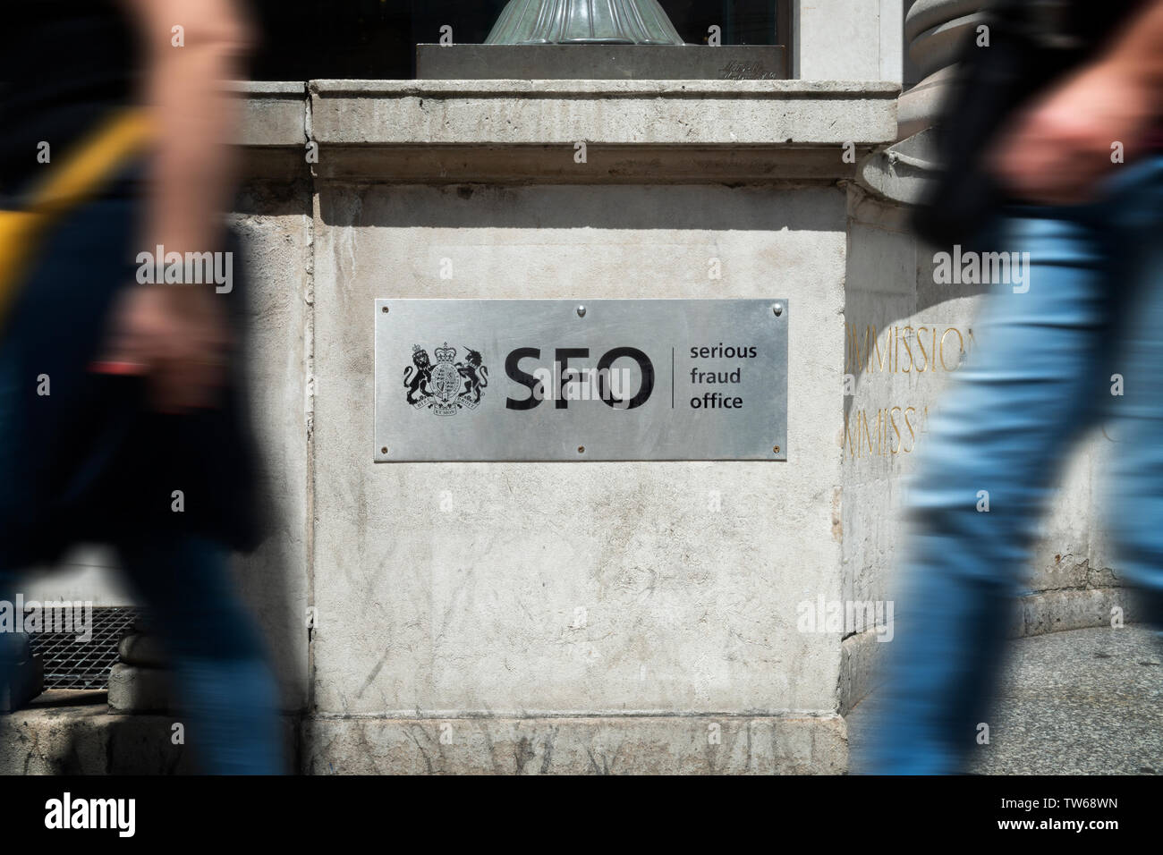 Pedestrians walk past the sign outside the headquarters of the Serious Fraud Office in London. Stock Photo