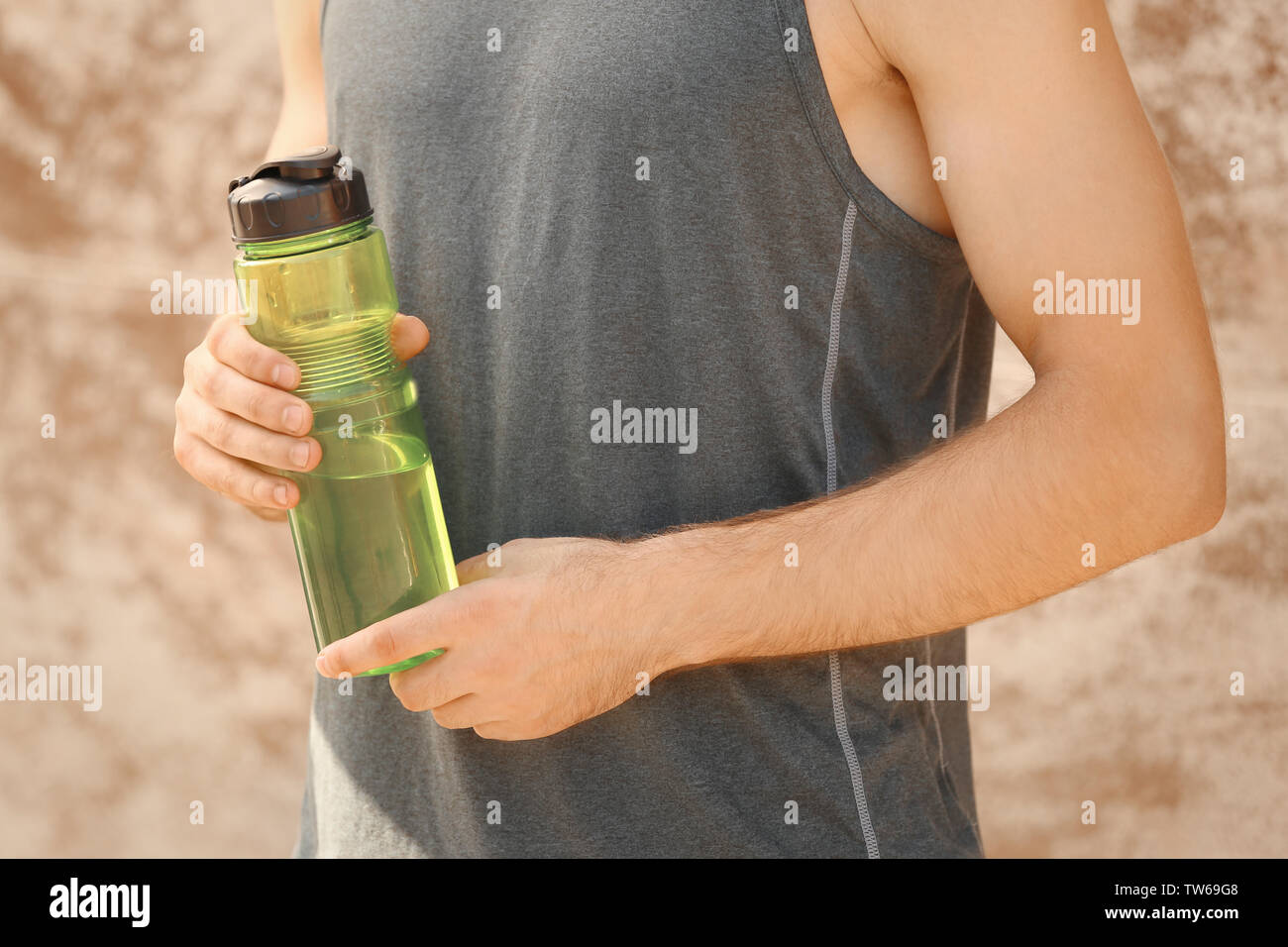Sporty young man with bottle of water outdoors Stock Photo - Alamy