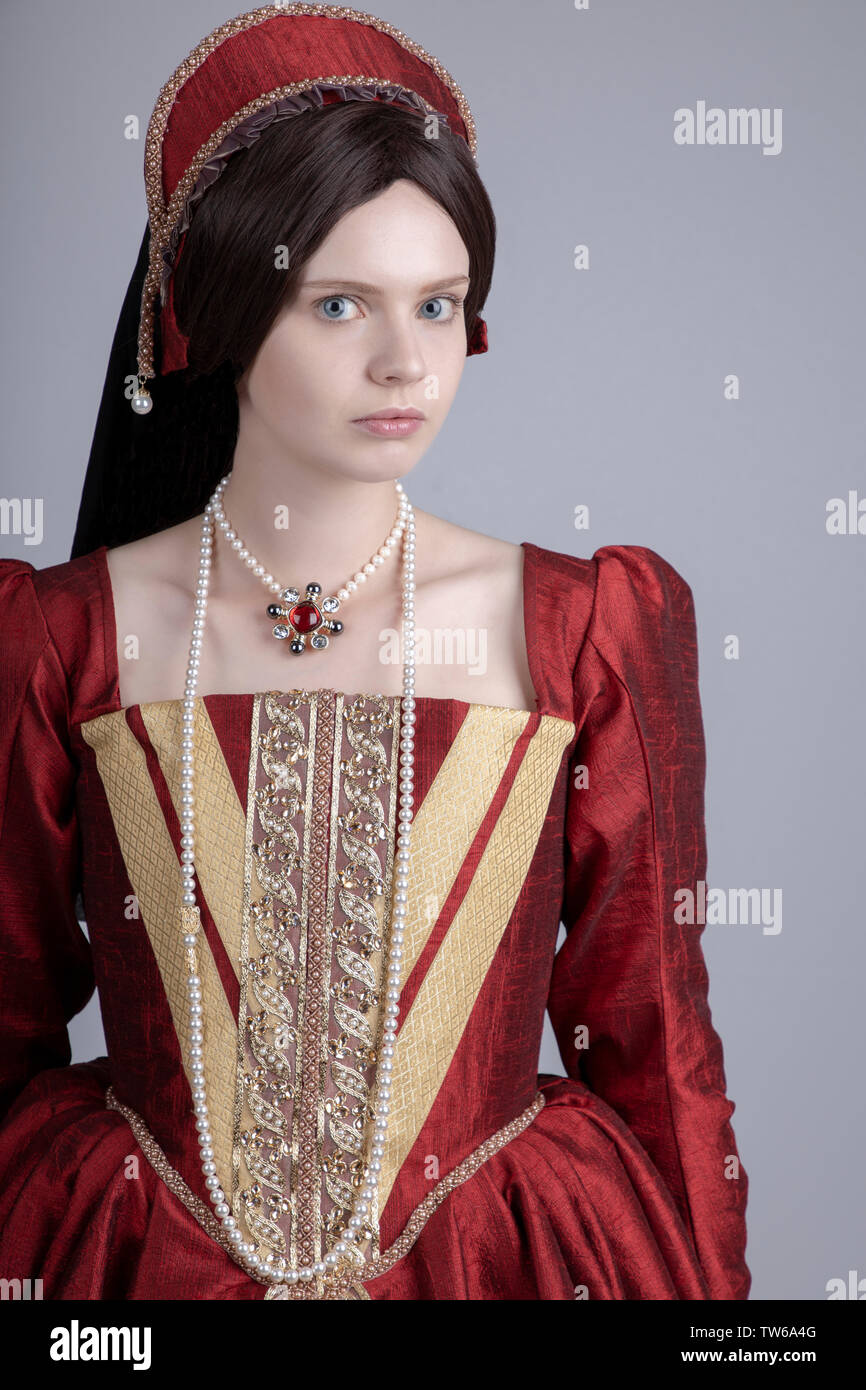 Tudor woman in red dress walking in garden Stock Photo Alamy