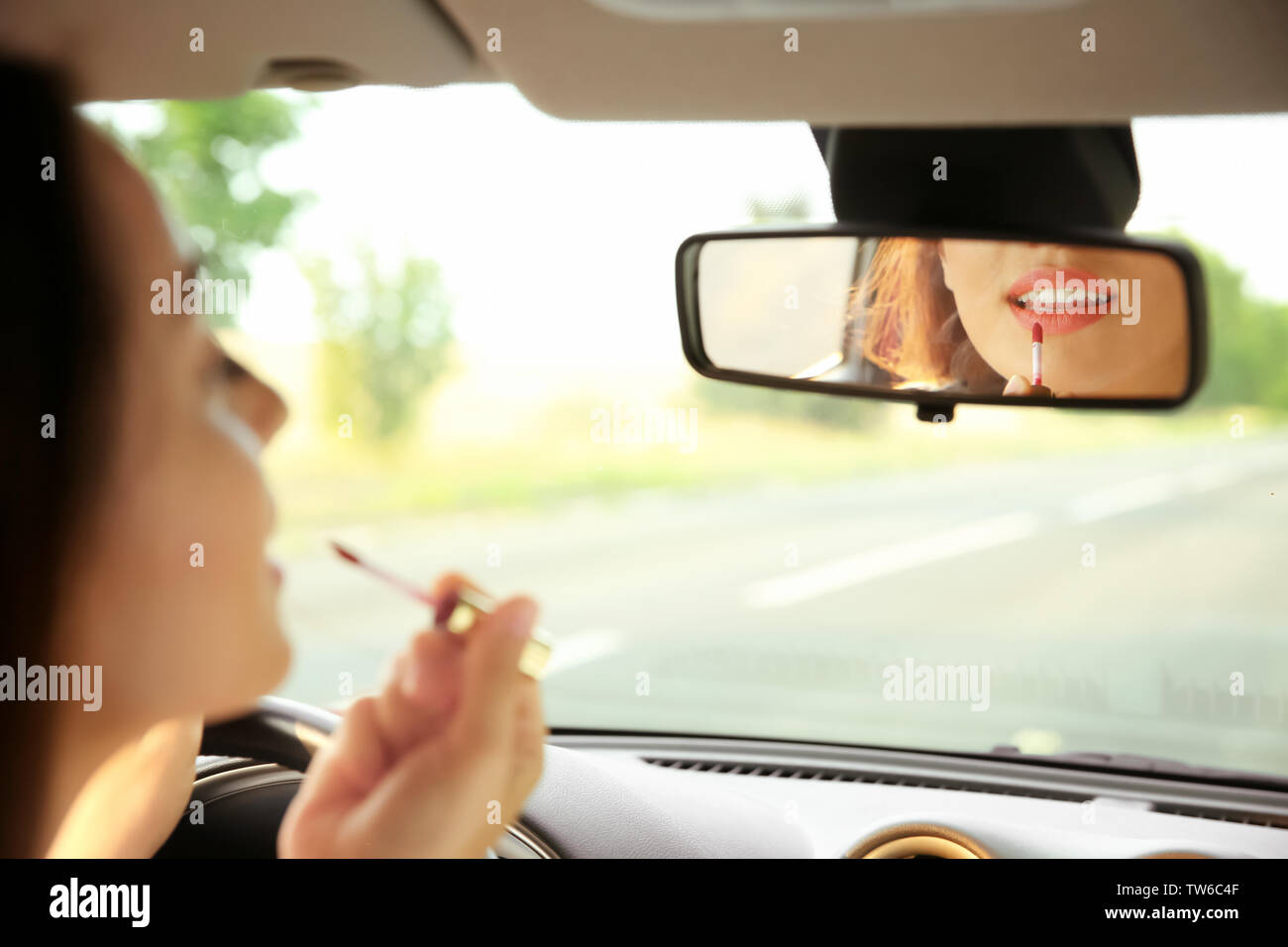 Woman applying makeup in car Stock Photo Alamy