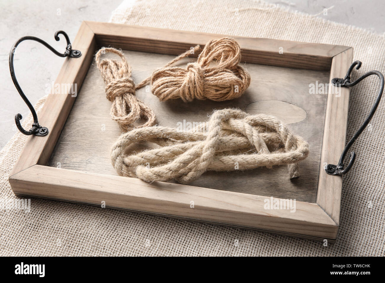 Hemp ropes on wooden tray Stock Photo - Alamy