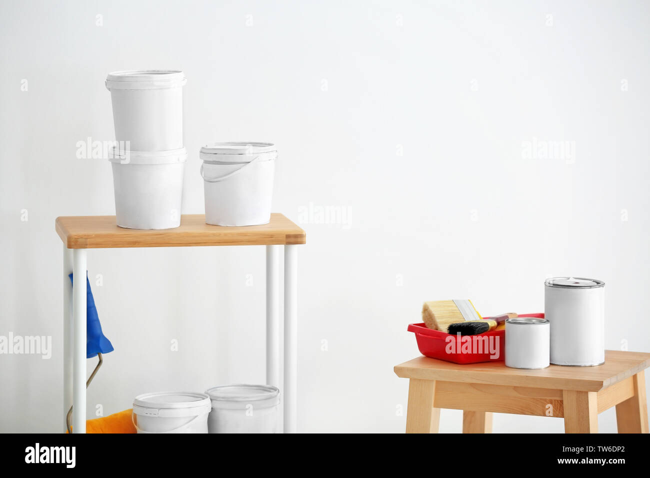 Many paint buckets and decorator's tools indoors Stock Photo Alamy