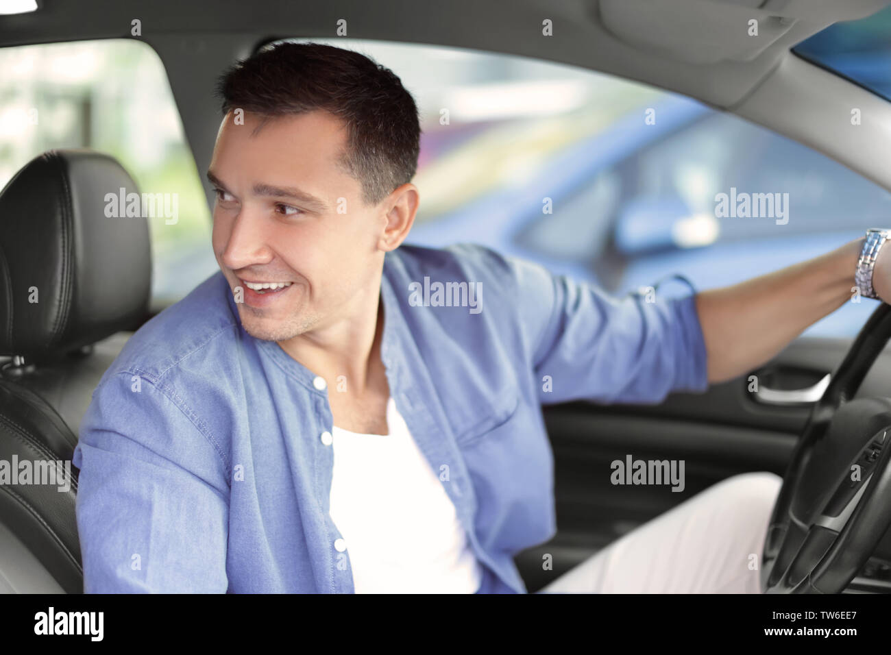 Handsome man driving a car Stock Photo - Alamy