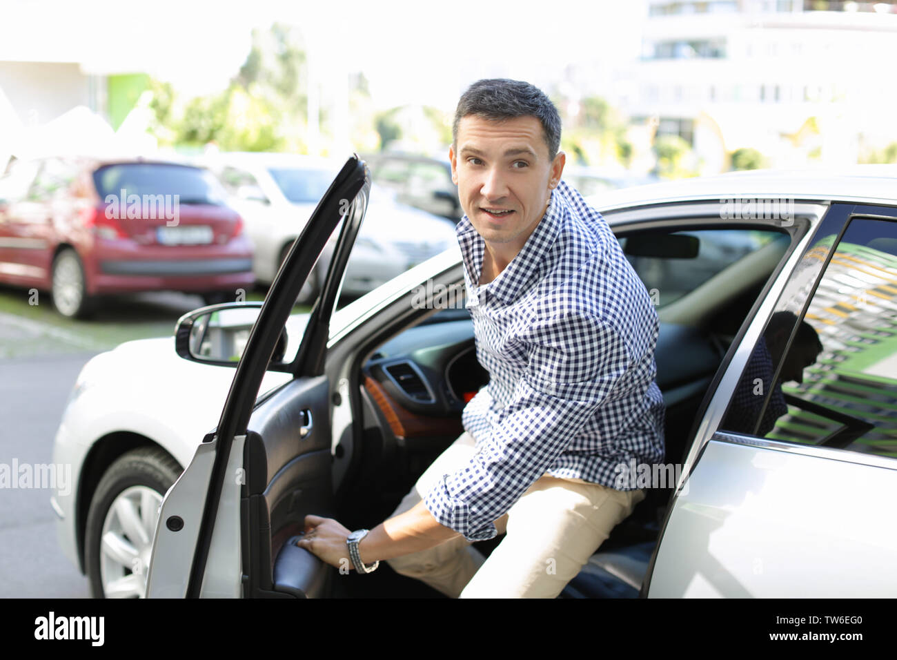 Man getting out of car Stock Photo