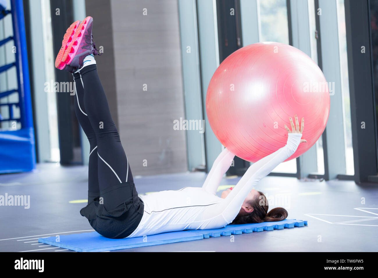 young asian girl doing yoga in modern gym Stock Photo - Alamy