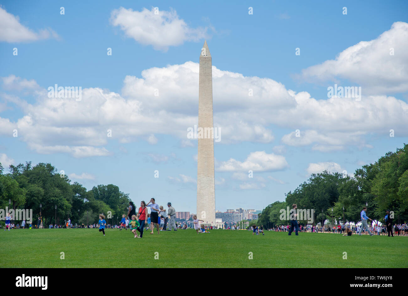 Visitors enjoy the lush grass and blue skies at the National Mall - America's Front Lawn - in Washington DC. Stock Photo