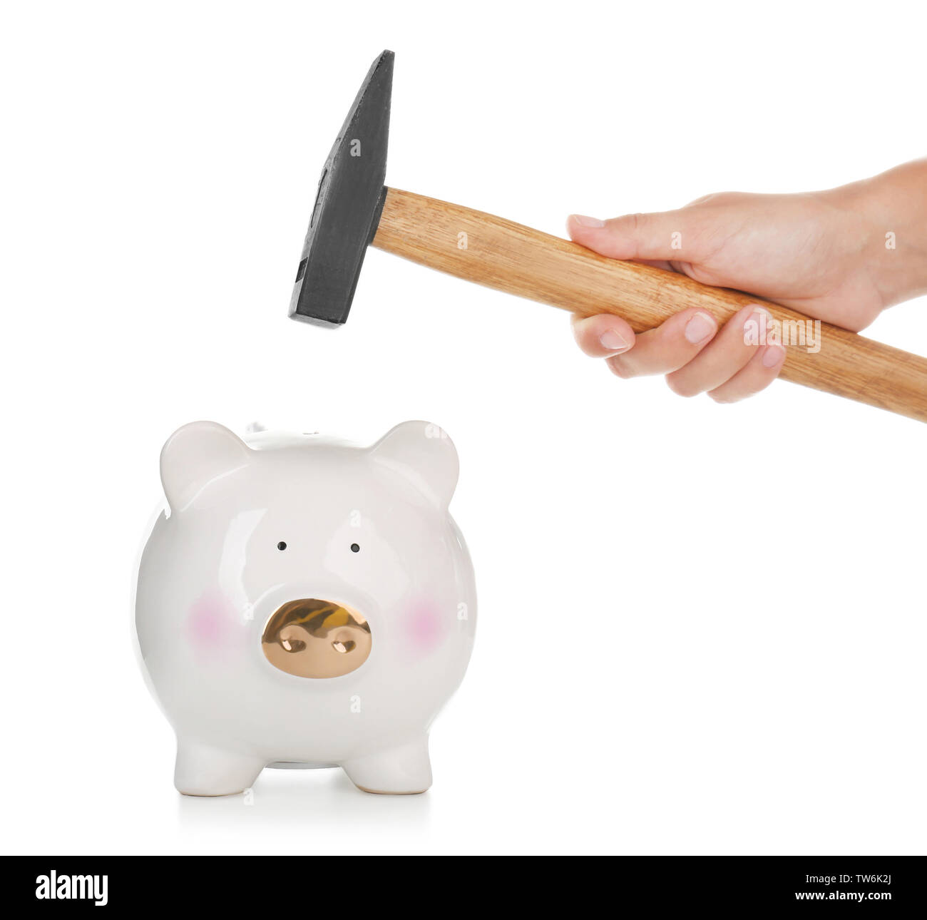 Hand of woman with hammer going to break piggy bank against white ...