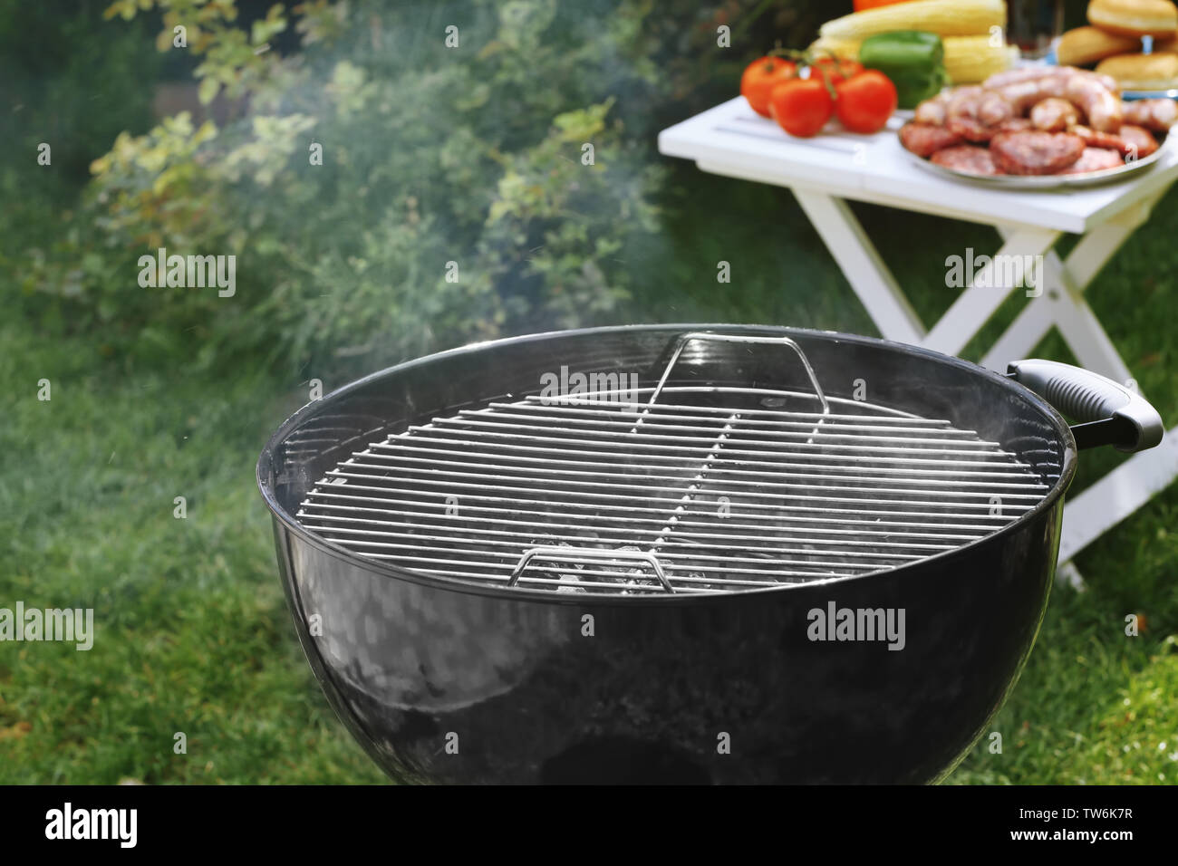Barbecue grill with smoke on backyard Stock Photo - Alamy