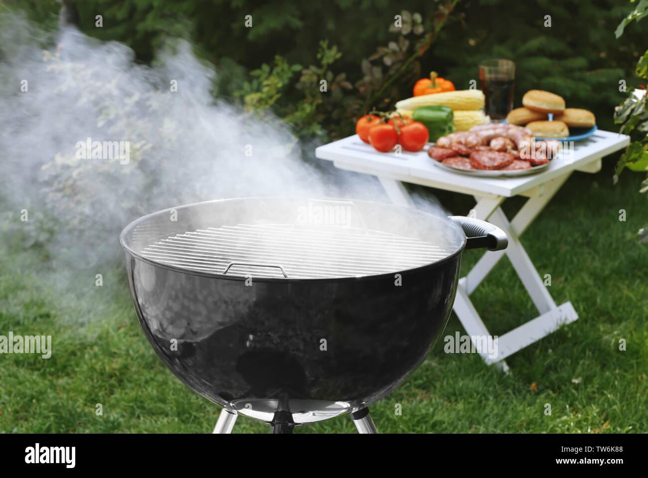 Barbecue grill with smoke on backyard Stock Photo - Alamy