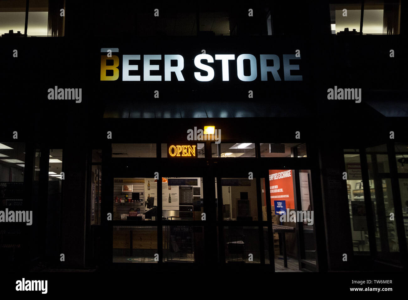 TORONTO, CANADA - NOVEMBER 14, 2018: Beer store logo on one of their shops in downtown Toronto, Ontario at night. Beer store is a chain of alcohol ret Stock Photo