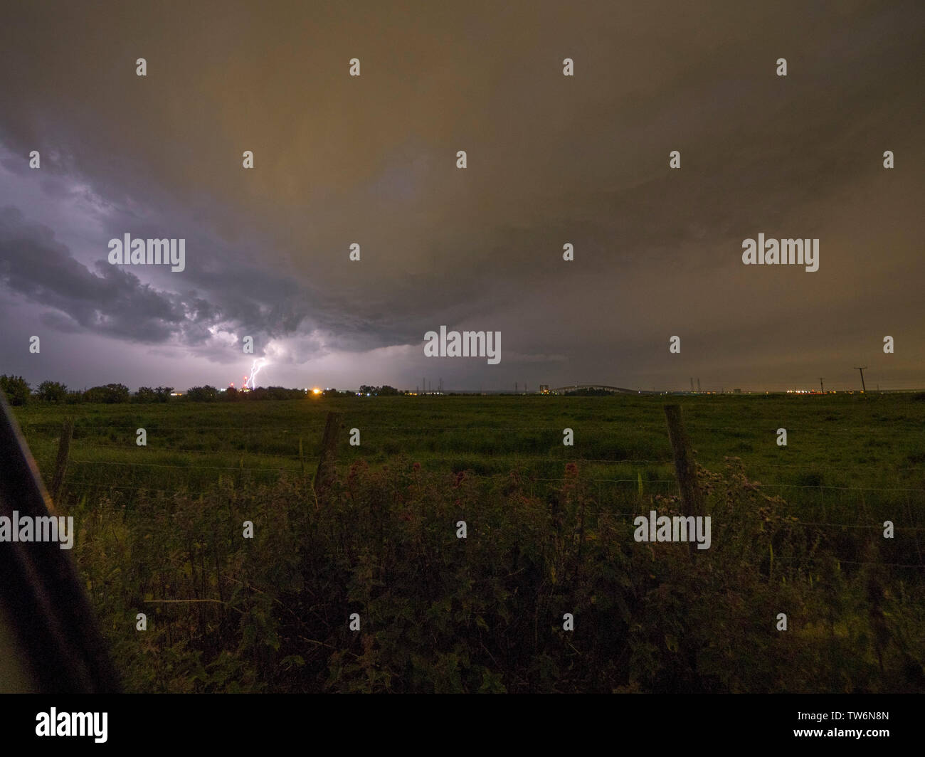 Elmley, Kent, UK. 18th June, 2019. UK Weather: a dramatic thunderstorm sets in over the Sheppey Crossing in Kent as seen from Elmley. Credit: James Bell/Alamy Live News Stock Photo