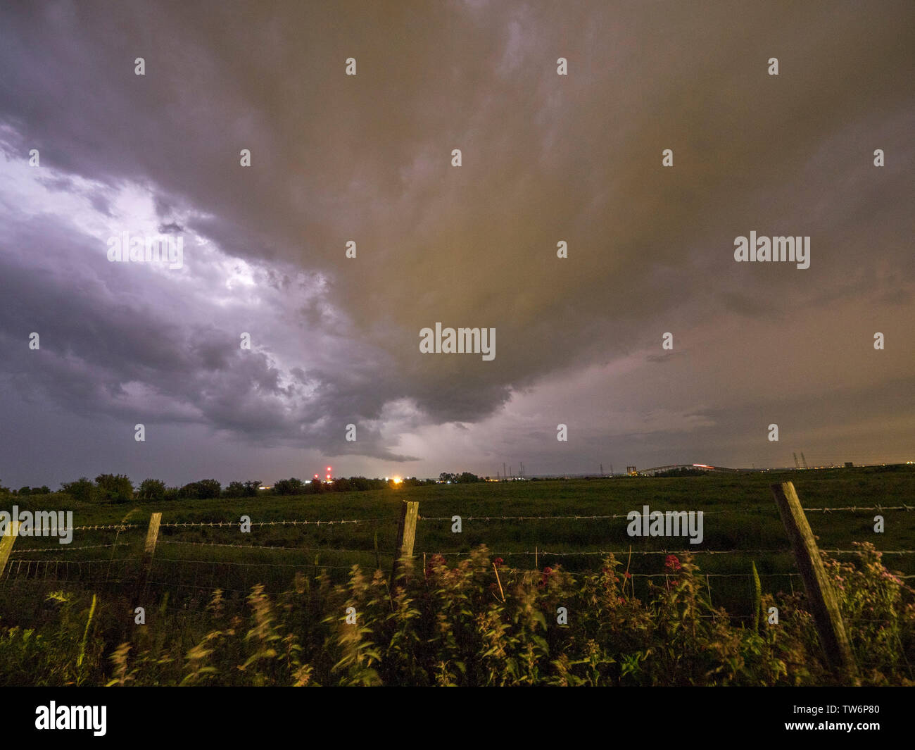 Elmley, Kent, UK. 18th June, 2019. UK Weather: a dramatic thunderstorm sets in over the Sheppey Crossing in Kent as seen from Elmley. Credit: James Bell/Alamy Live News Stock Photo