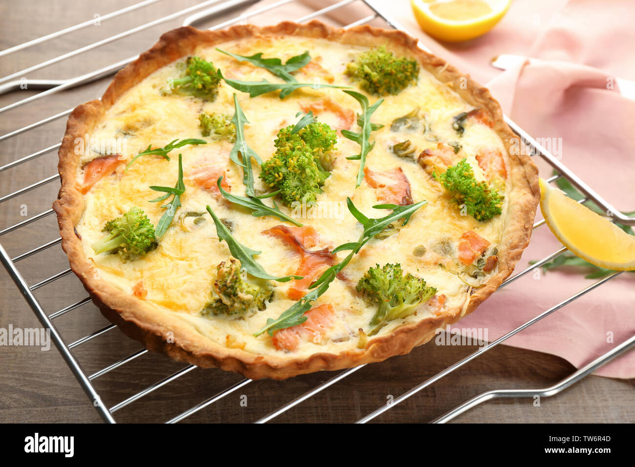 Tasty salmon quiche on cooling rack Stock Photo