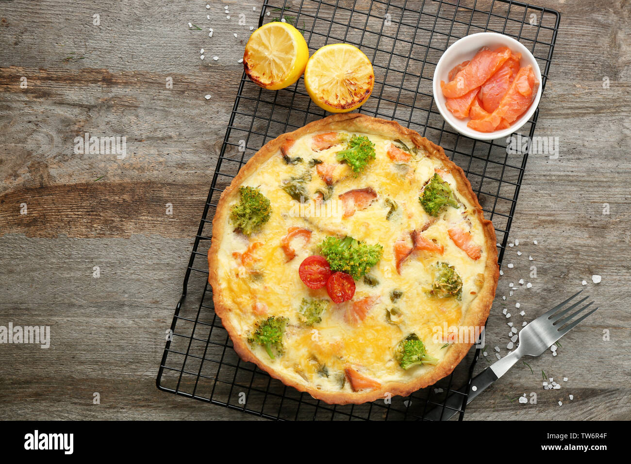 Tasty salmon quiche on cooling rack Stock Photo