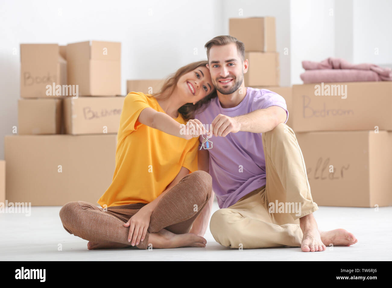 Young couple with key at new home Stock Photo - Alamy
