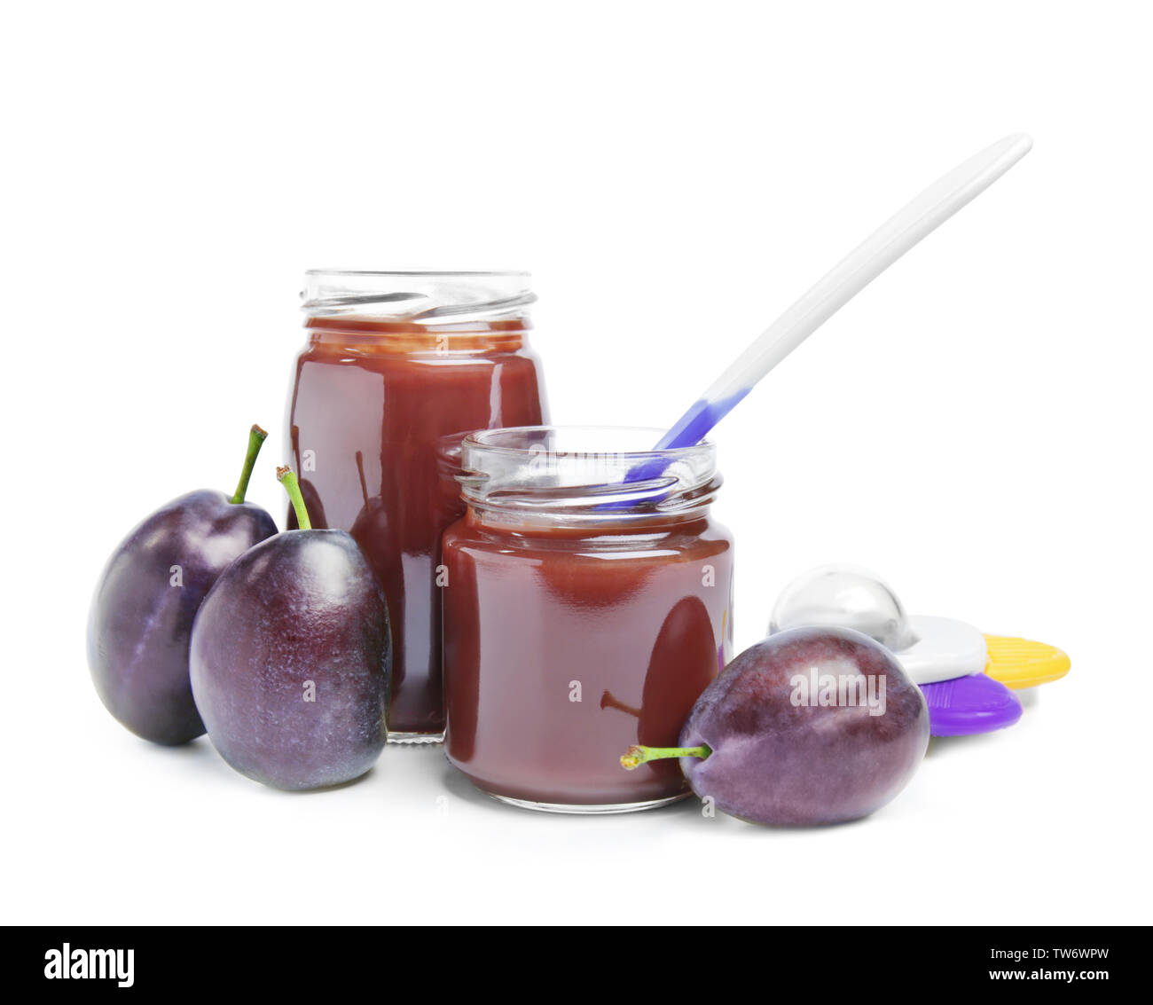 Jars with baby food and plums on white background Stock Photo Alamy