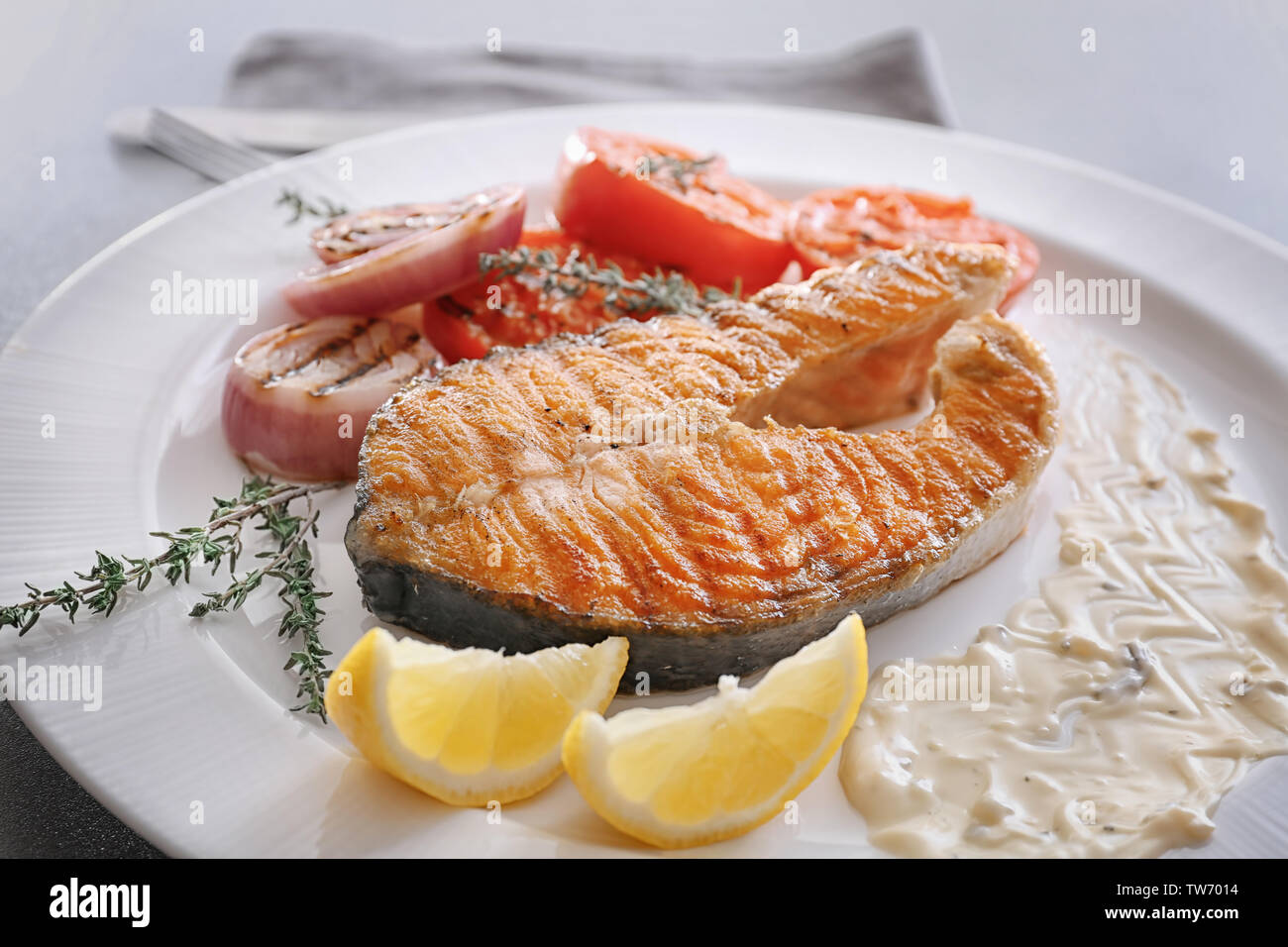 Grilled salmon steak with vegetables on plate, close up Stock Photo - Alamy