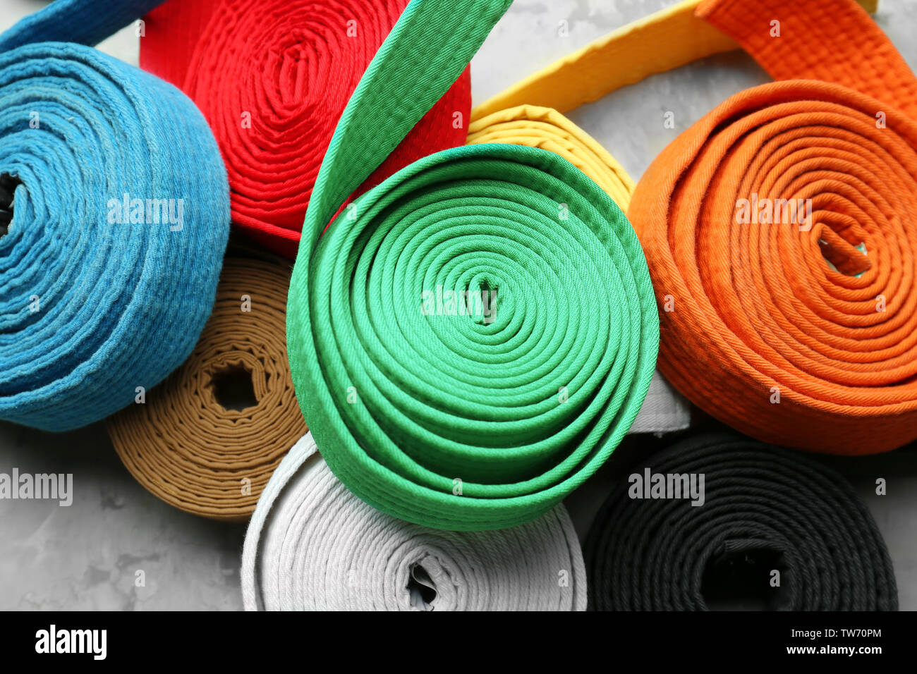 Colorful karate belts on grey background Stock Photo Alamy