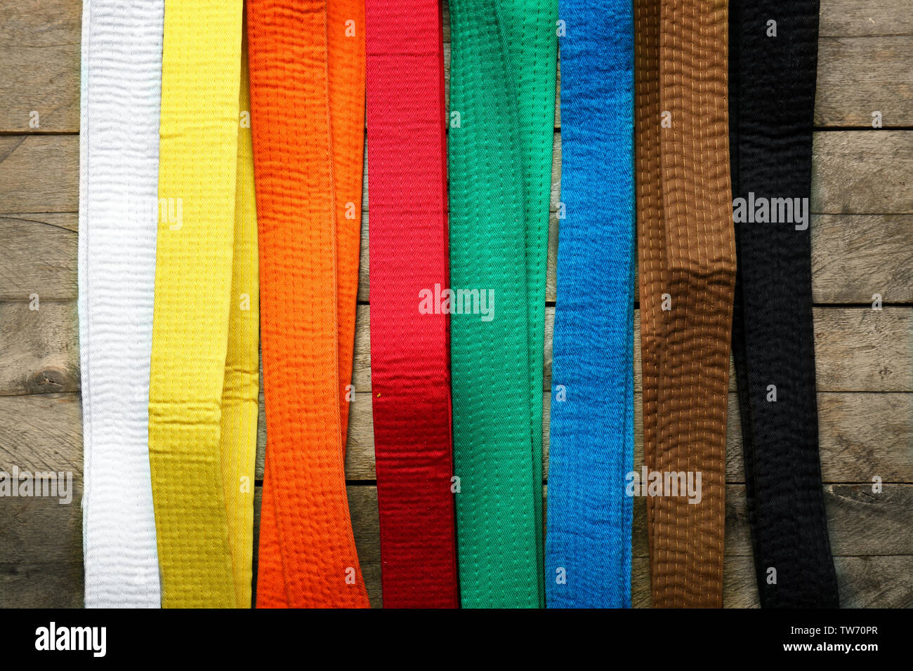 Colorful karate belts on wooden background Stock Photo Alamy