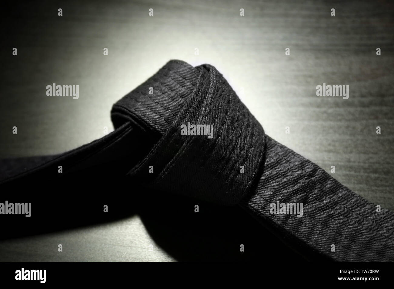 Black karate belt on dark background Stock Photo - Alamy