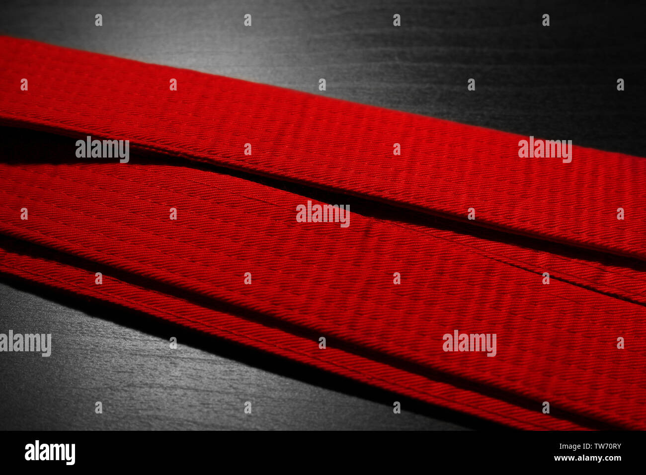 Red karate belt on dark background Stock Photo - Alamy