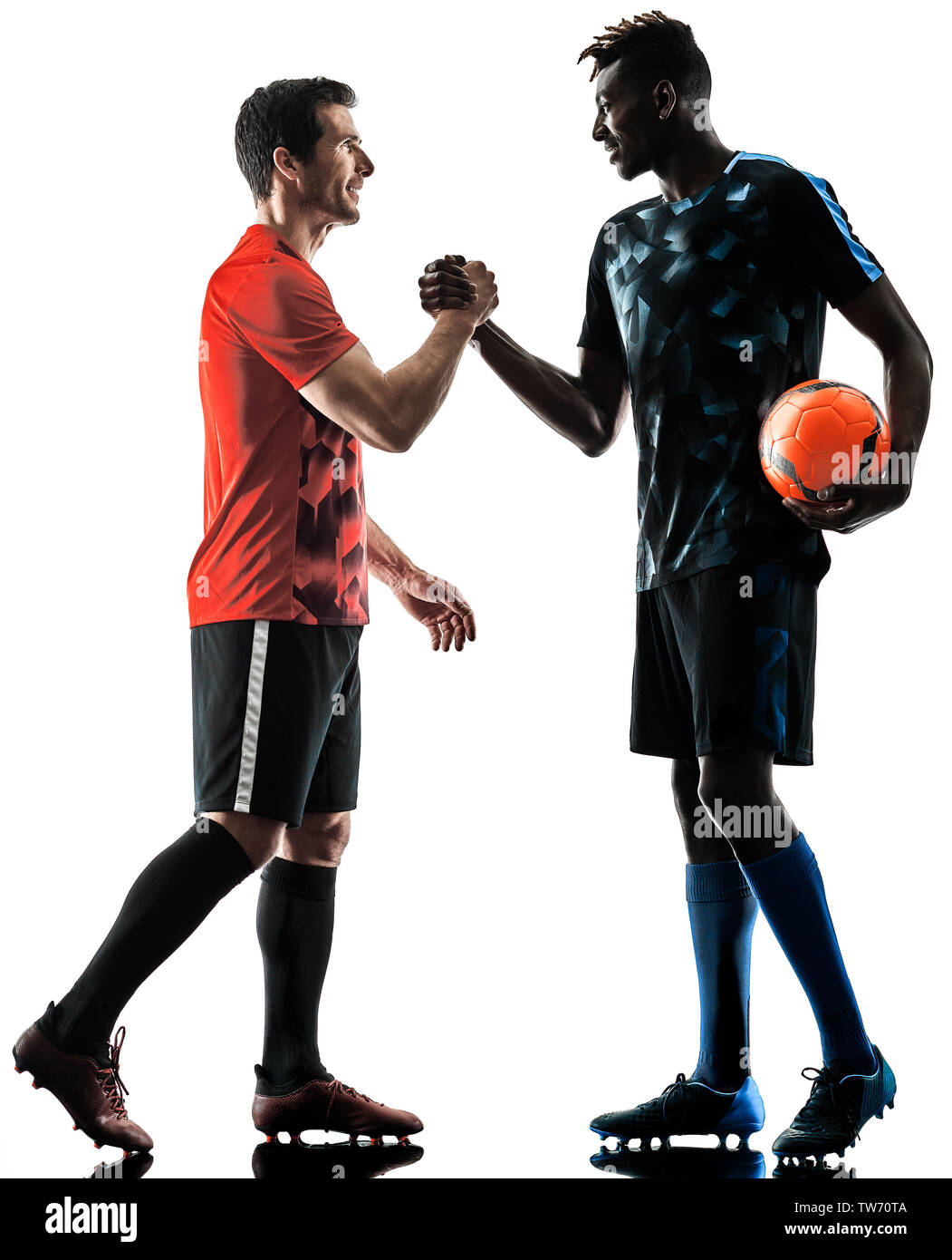 two soccer players men in studio silhouette isolated on white background Stock Photo