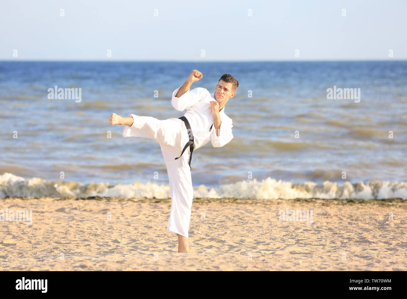 Young man practicing karate outdoors Stock Photo - Alamy