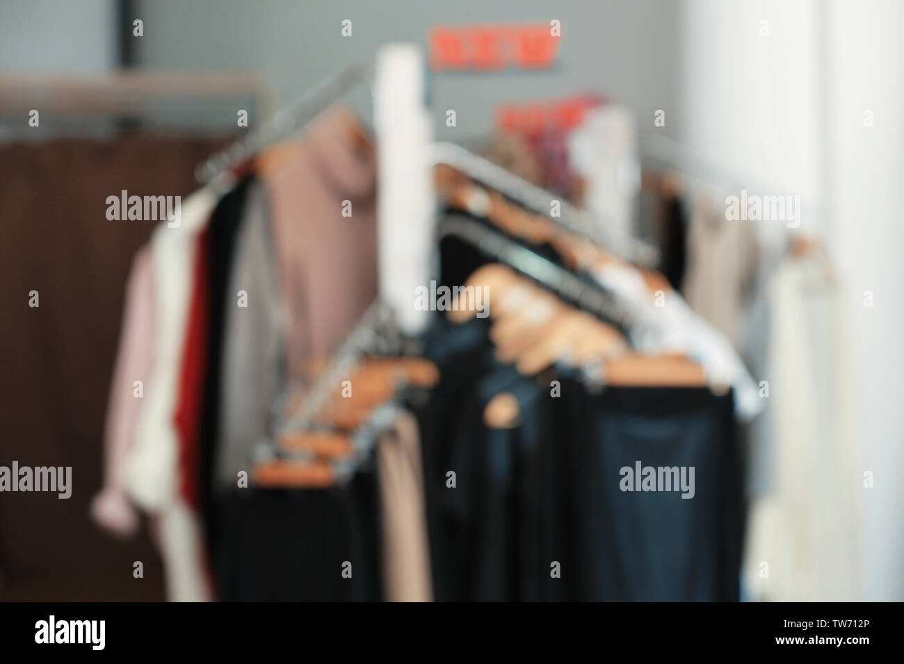 Blurred view of clothes rack in boutique Stock Photo - Alamy