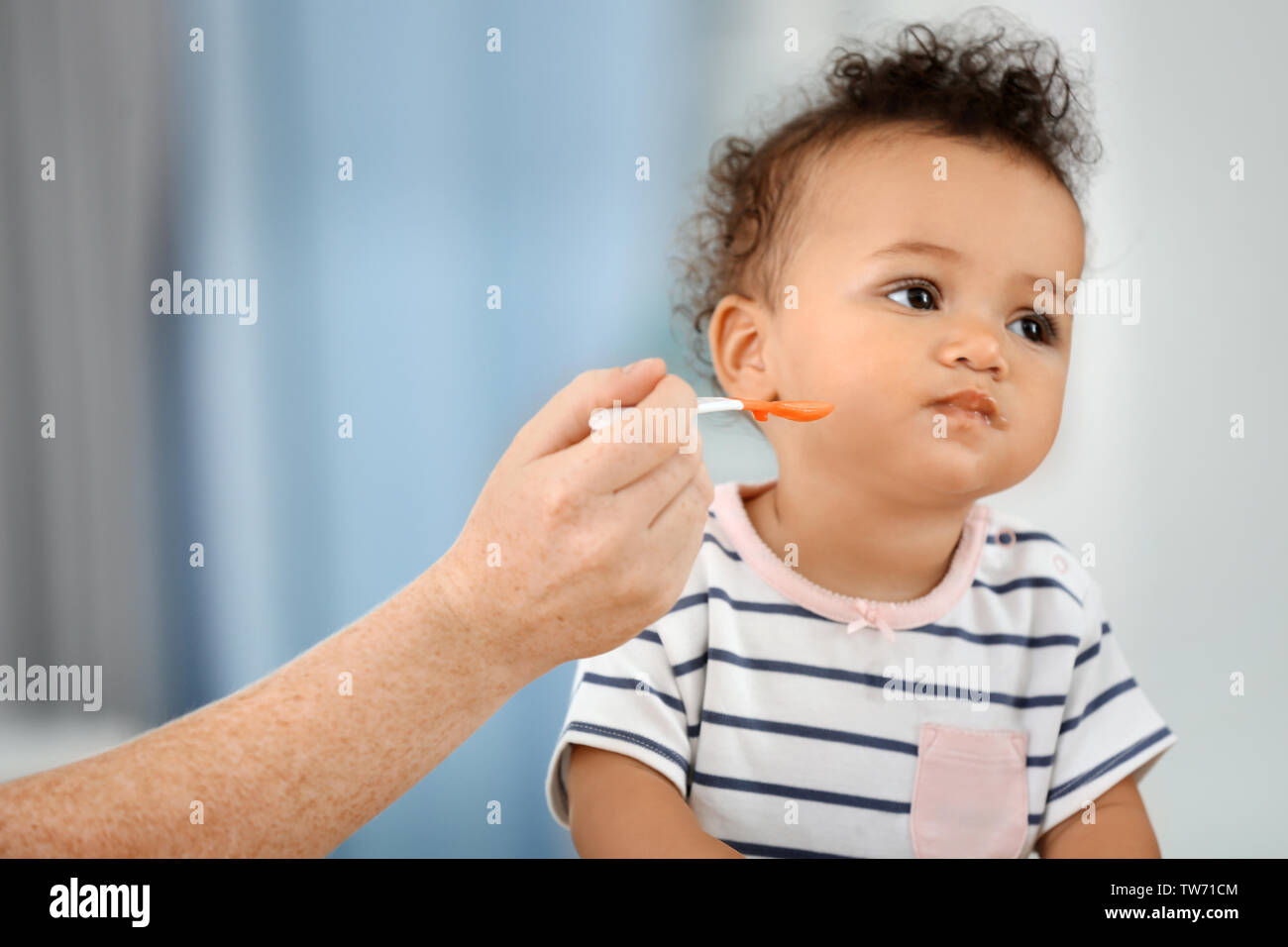 Baby spoon eat african hi-res stock photography and images - Alamy