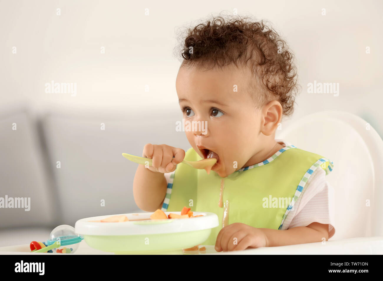 Baby spoon eat african hi-res stock photography and images - Alamy