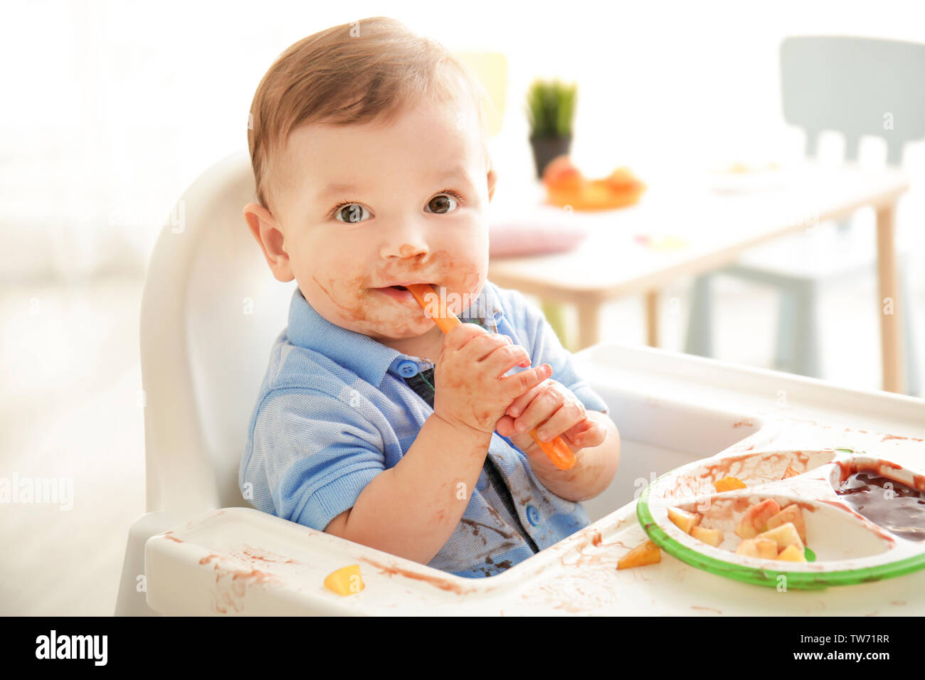 cute-messy-baby-eating-puree-at-home-stock-photo-alamy