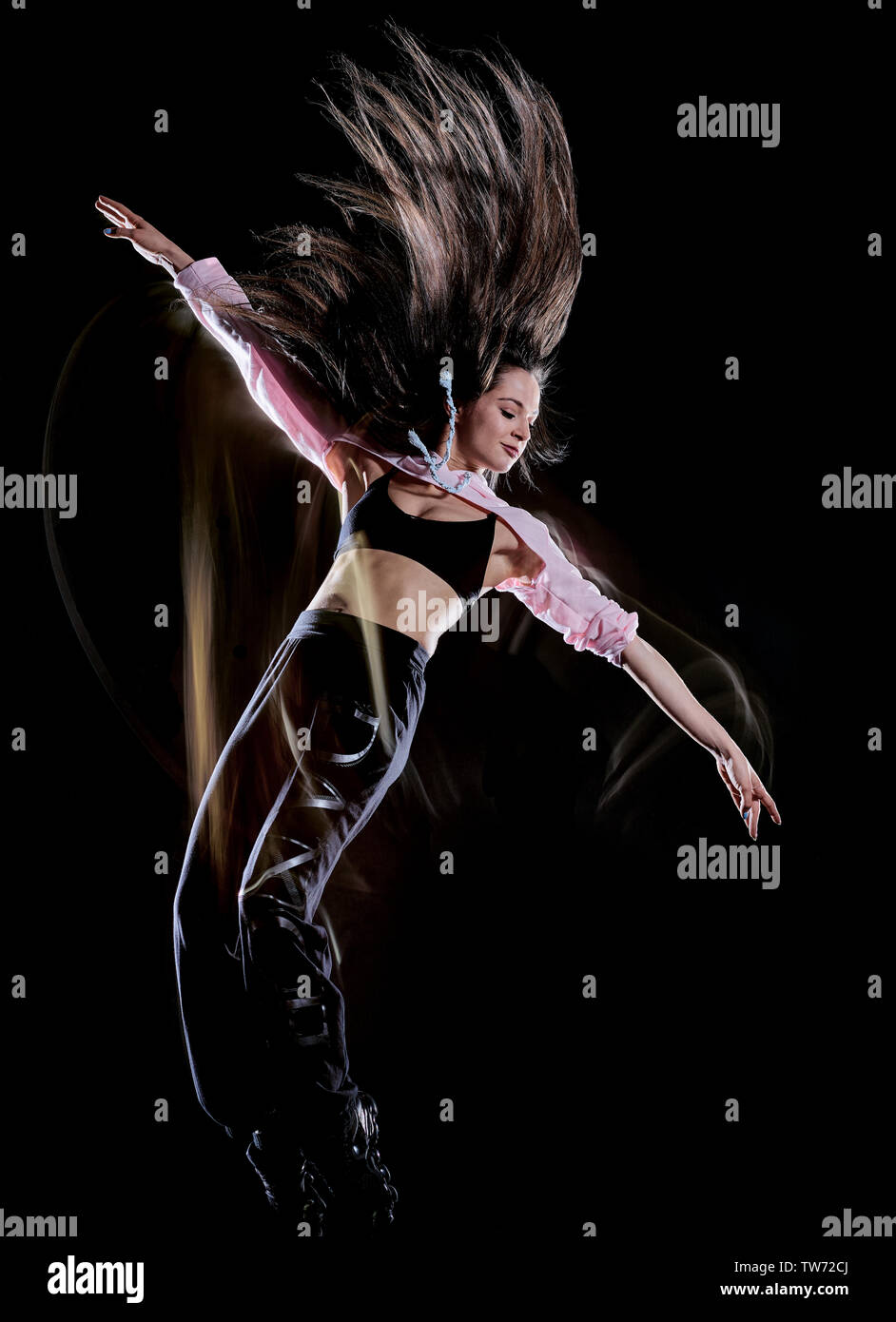one caucasian young woman modern  dancer dancing isolated on black background with  light painting motion blur speed effect Stock Photo