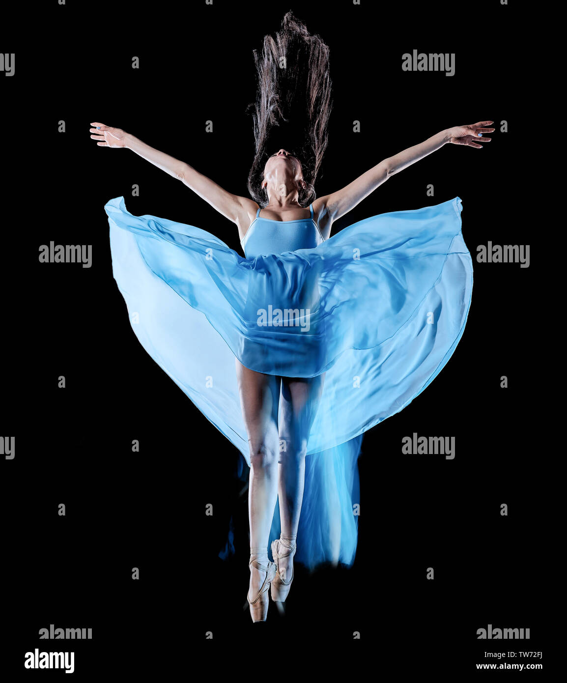 one caucasian young woman ballet dancer dancing isolated on black background with  light painting motion blur speed effect Stock Photo