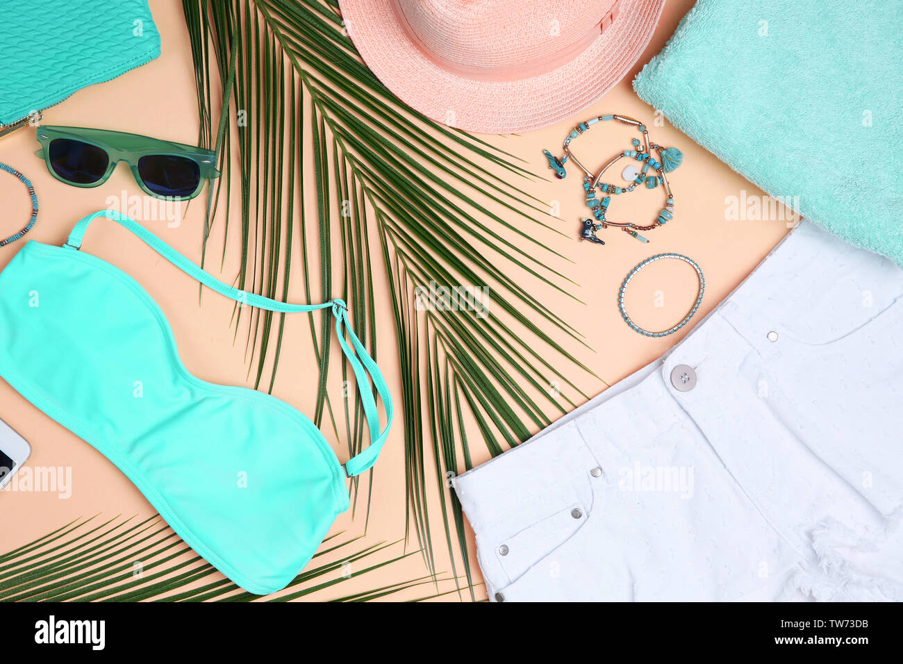 Composition with mint clothes and accessories on apricot background Stock Photo
