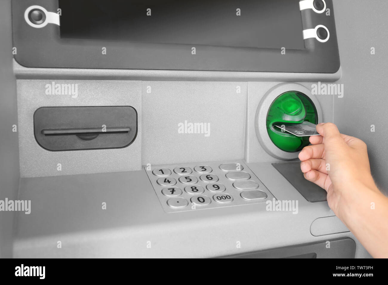 Woman inserting credit card into cash machine Stock Photo - Alamy
