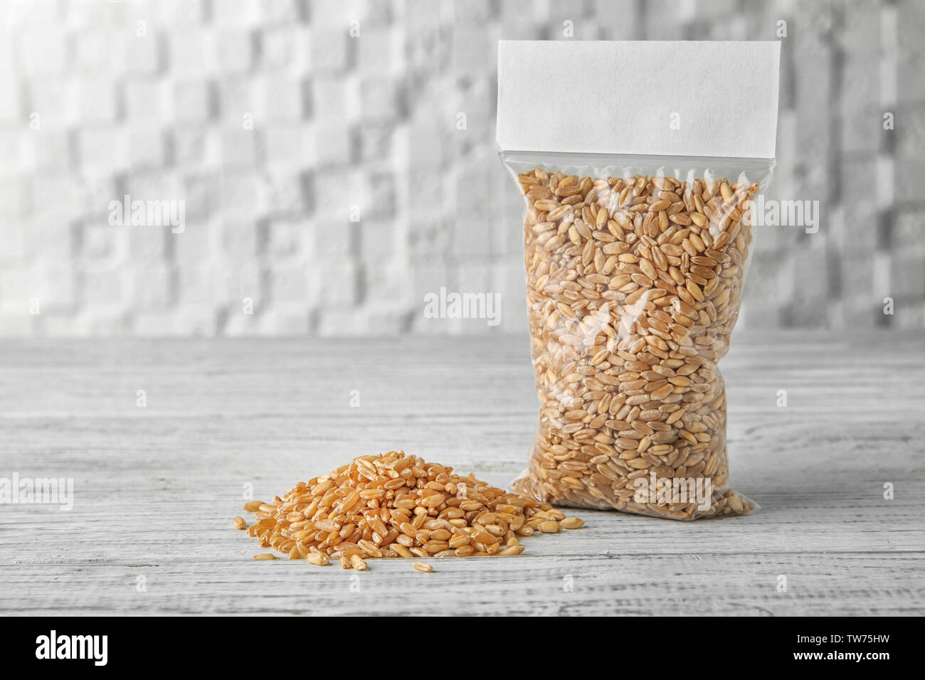 Package with wheat grass seeds on table Stock Photo Alamy