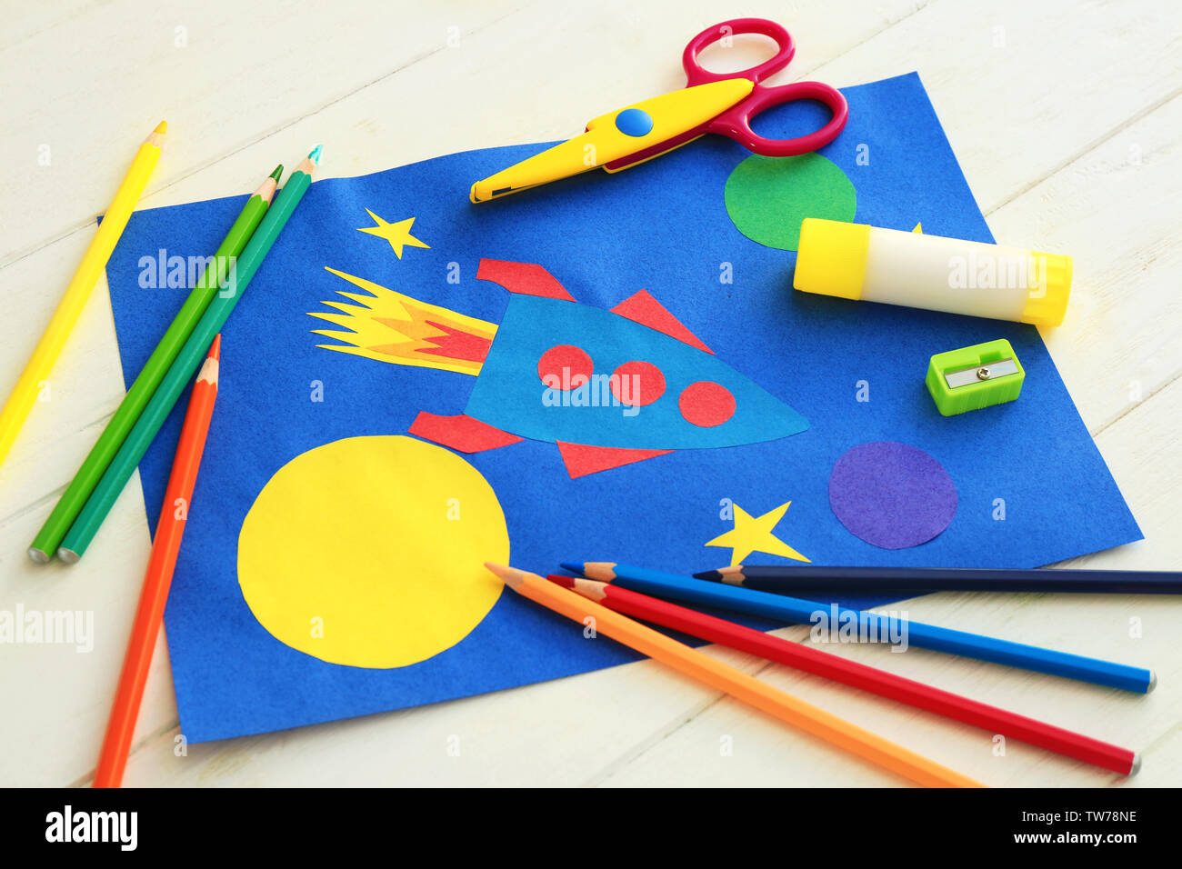 Child's applique of rocket on wooden table Stock Photo