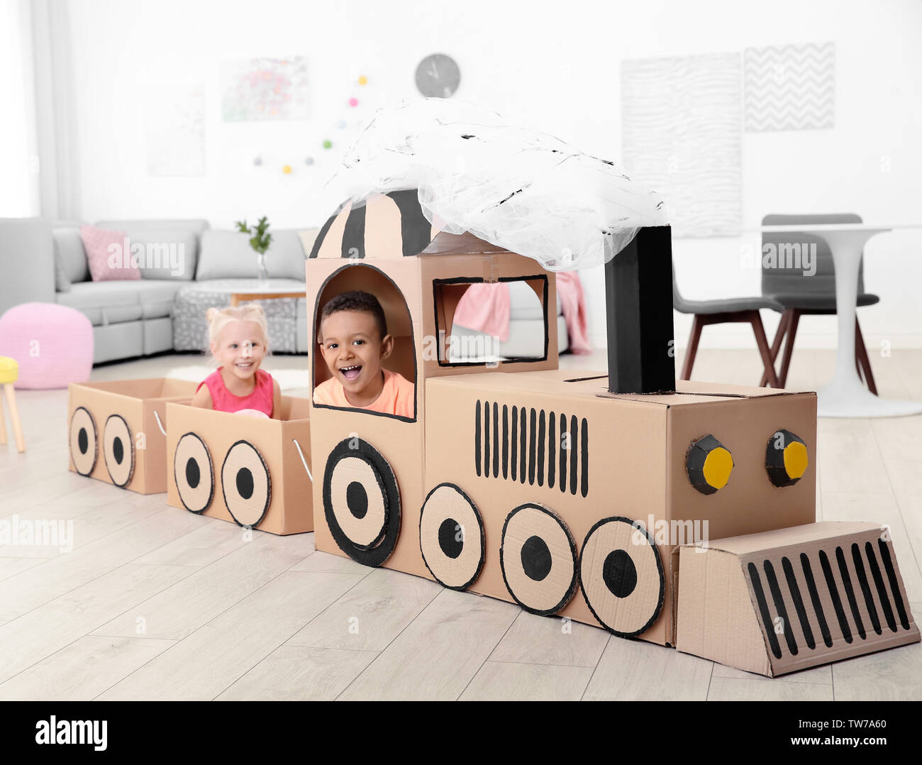Cute children playing with cardboard train at home Stock Photo Alamy