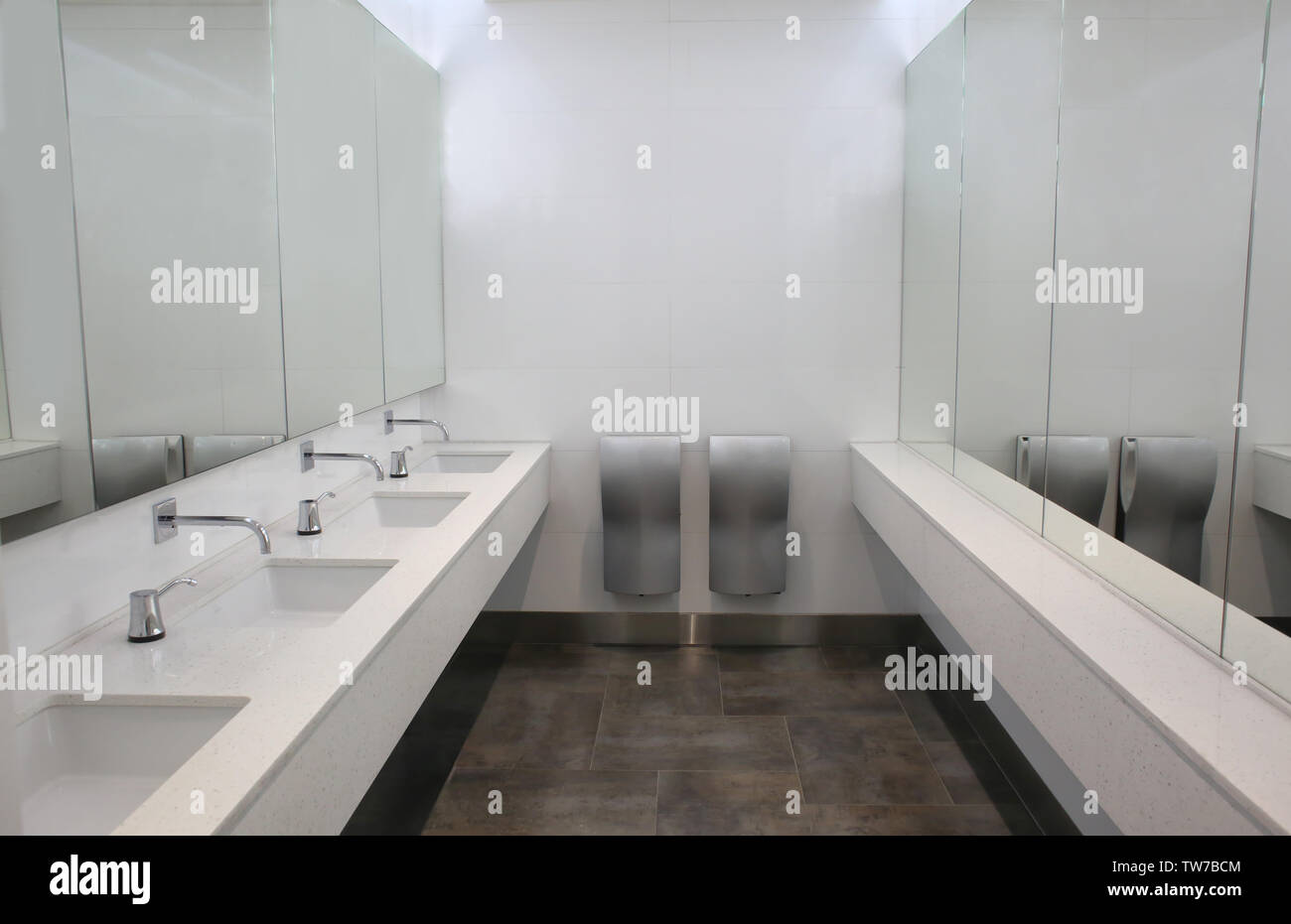 Modern sinks with mirrors in public toilet Stock Photo Alamy