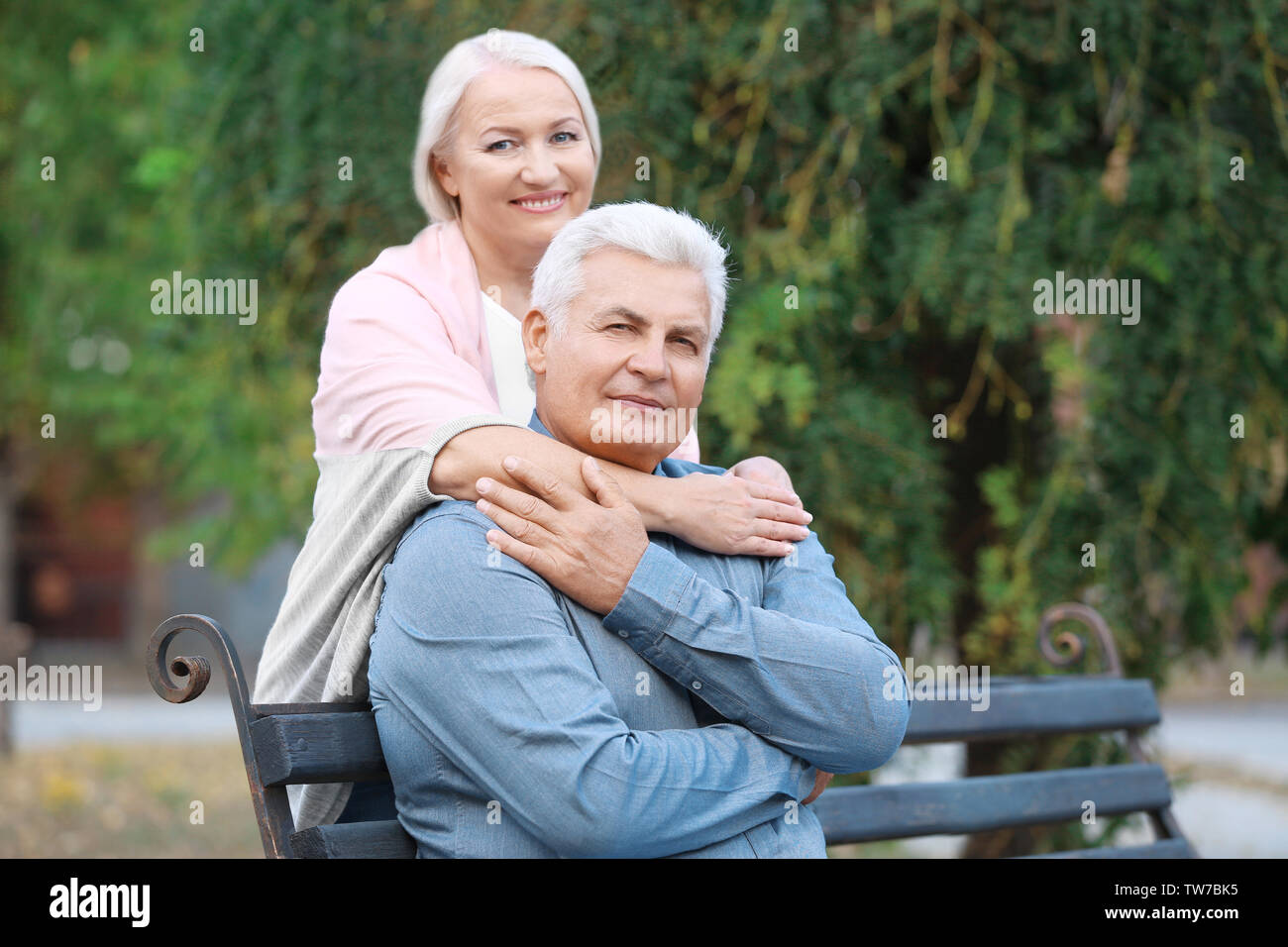 Mature couple sitting on bench outdoors Stock Photo - Alamy