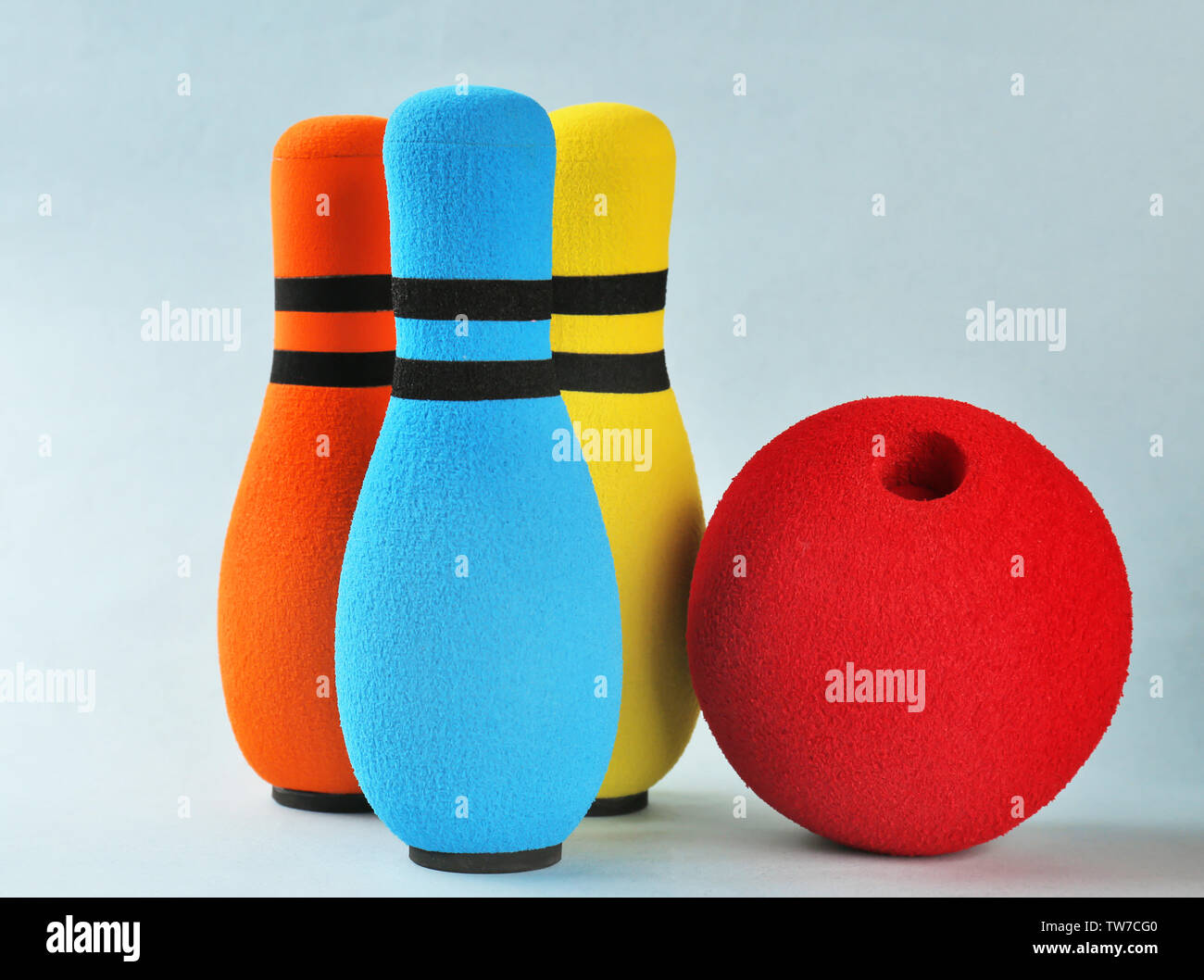 Bright bowling pins and ball on light background Stock Photo