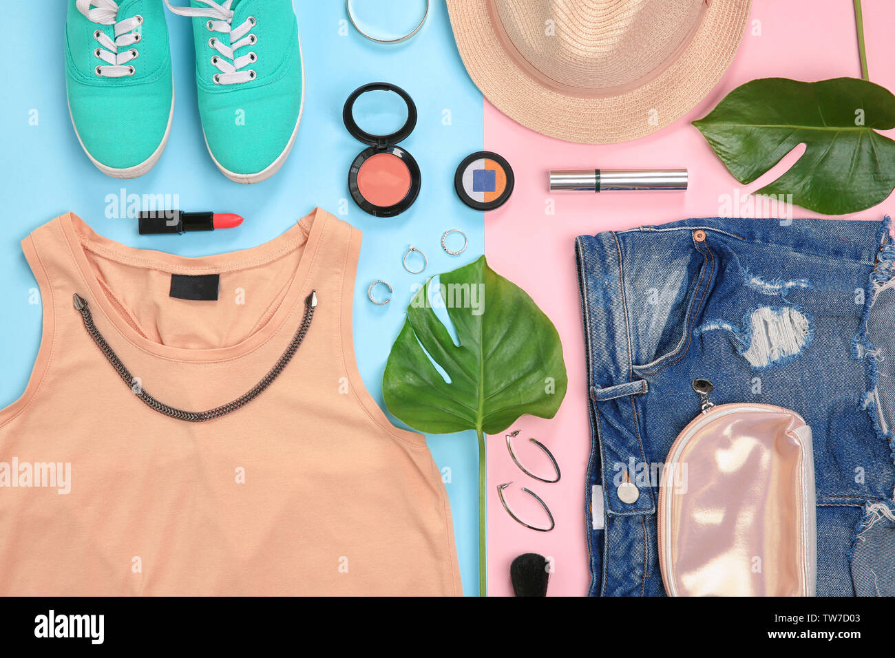 Composition with trendy clothes and tropical leaves on color background ...