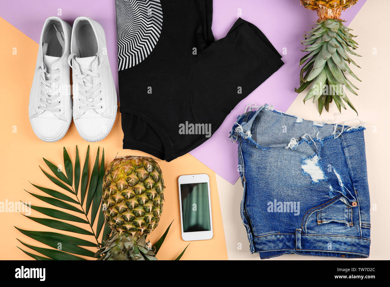 Composition with trendy clothes and tropical leaves on color background ...