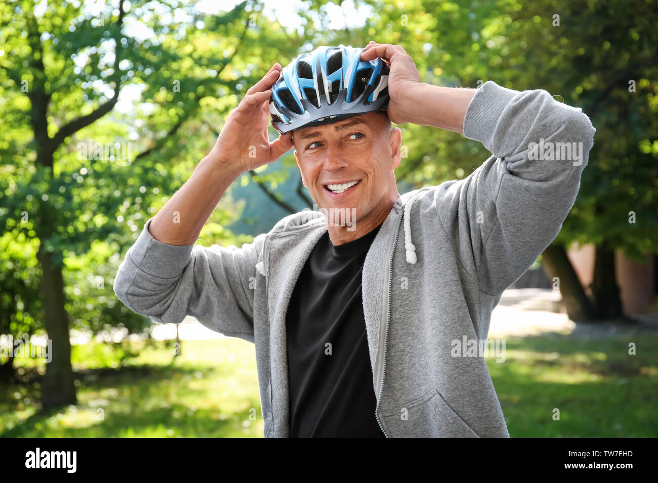 Mature adult wearing helmet hi-res stock photography and images - Alamy