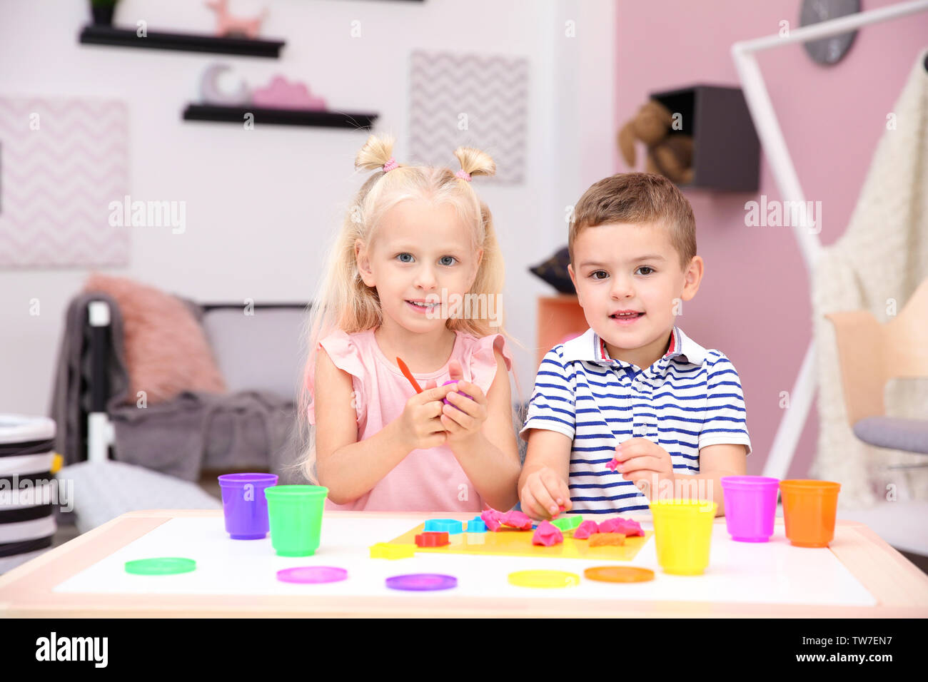 Cute little children modeling from playdough at home Stock Photo